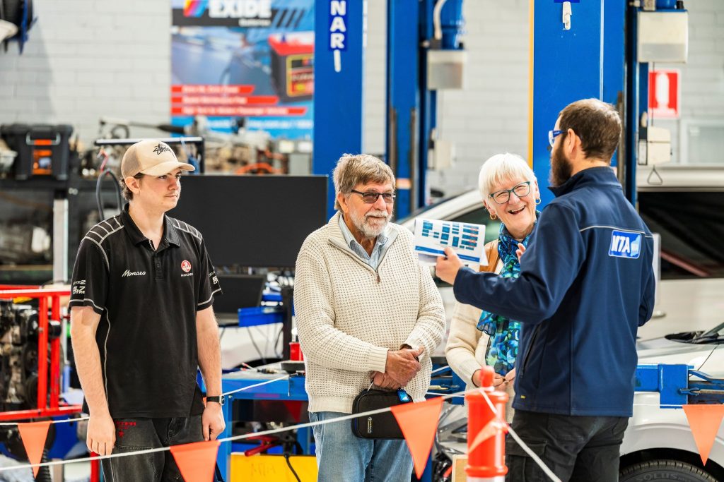 Visitors watch an automotive training demonstration inside the MTA WA Balcatta workshop during the 2026 Open Day.